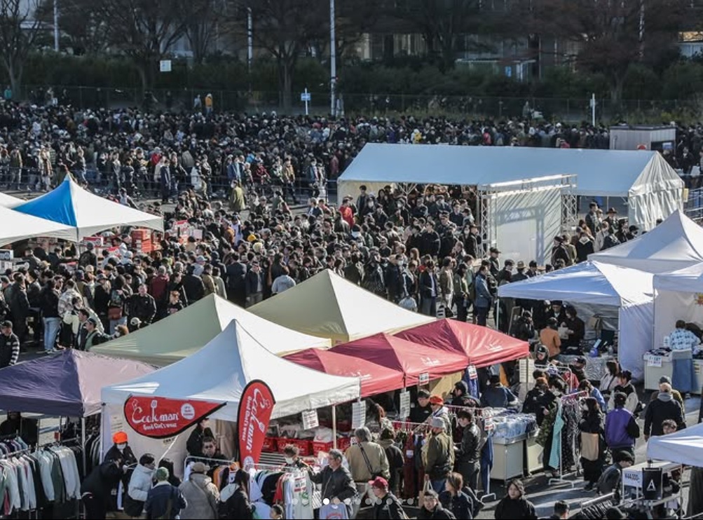 Shoppers browsing American casual clothing booths at the Inazuma Festival